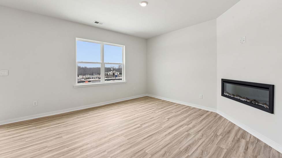 Living room with electric fireplace and large window