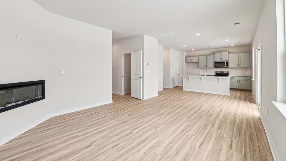 Living room with electric fireplace and large window