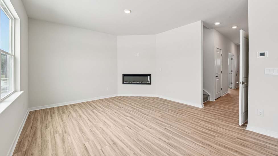 Living room with electric fireplace and large window