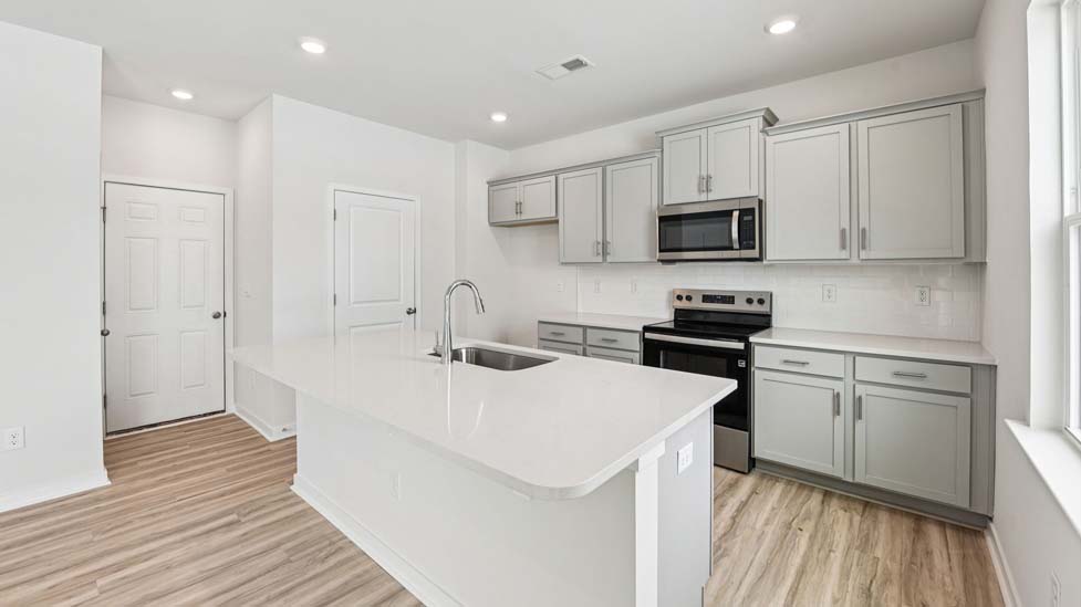 kitchen and island with stainless steel appliance