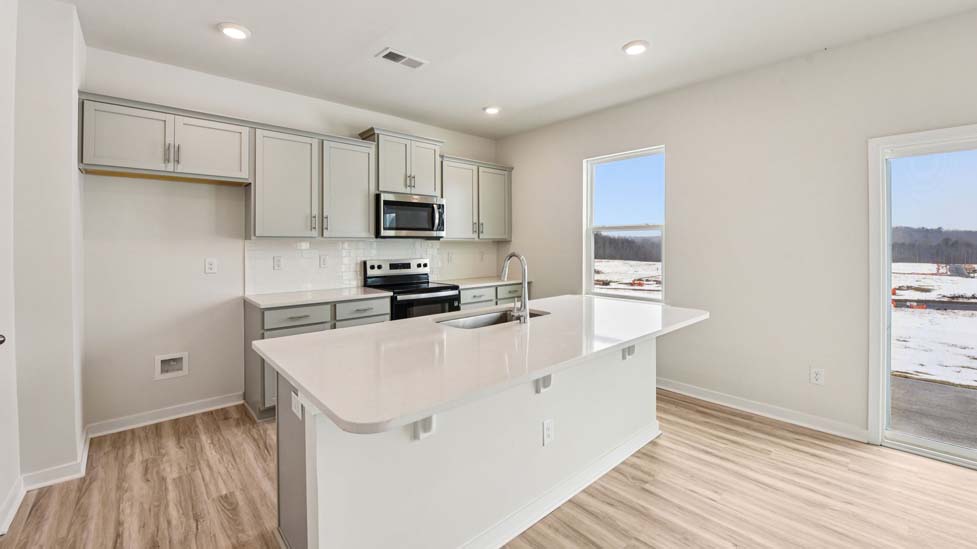 kitchen and island with stainless steel appliance