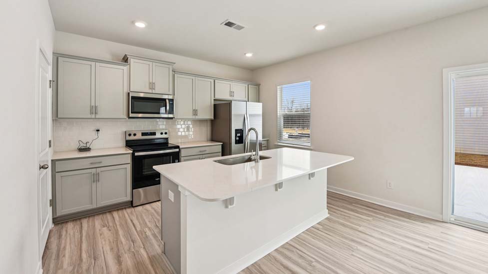 Kitchen and island with stainless steel appliances