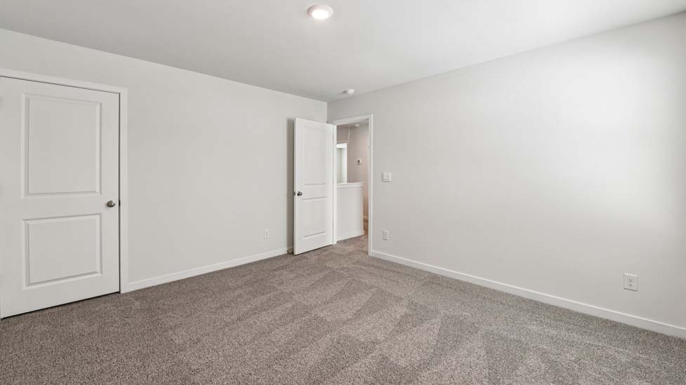 Carpeted bedroom with large windows