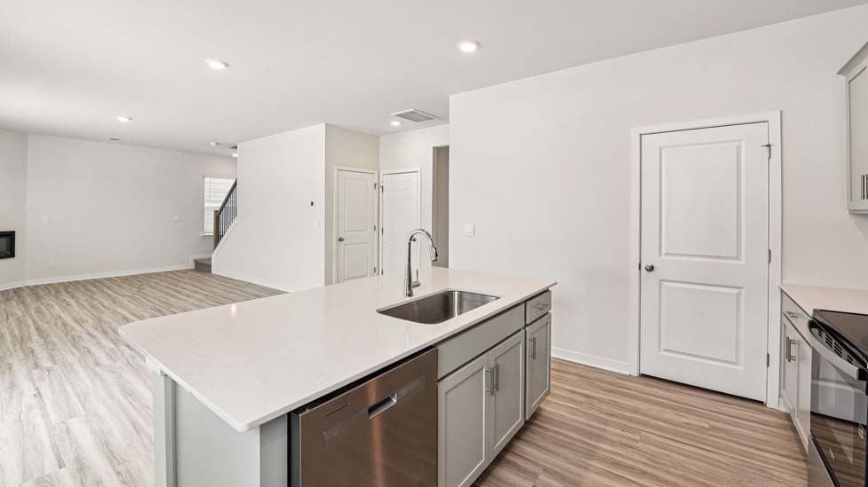 Kitchen and island with stainless steel appliances