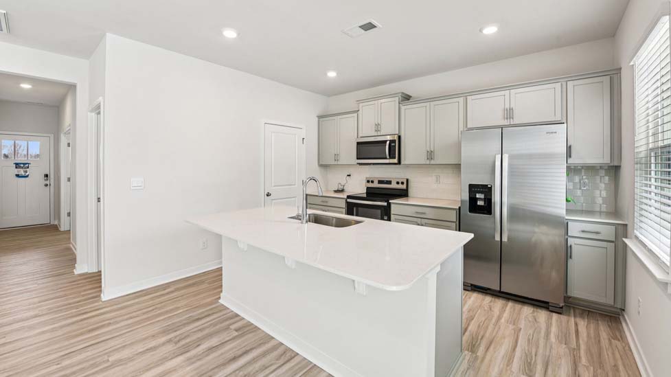 Kitchen and island with stainless steel appliances