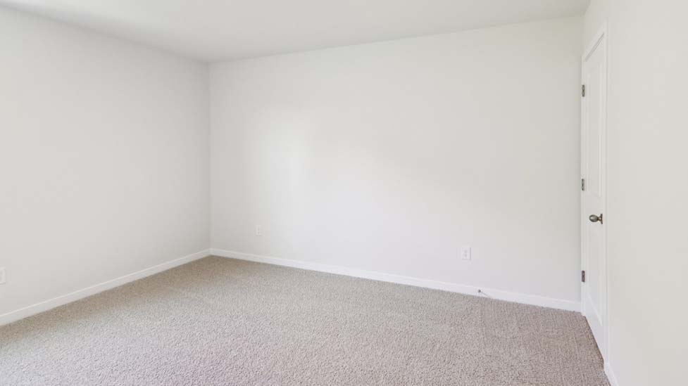 Carpeted bedroom with large window