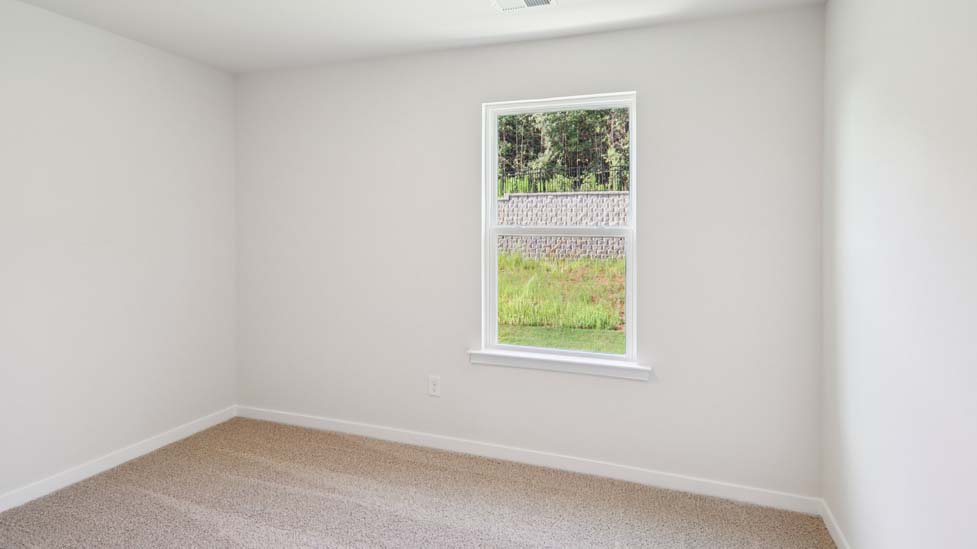 Carpeted bedroom with large window