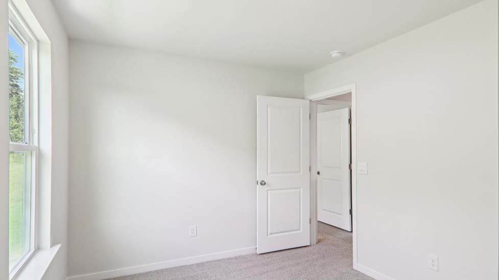 Carpeted bedroom with large window
