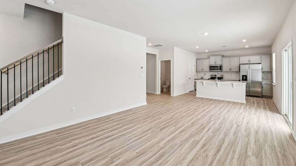 Living room beside kitchen with electric fireplace