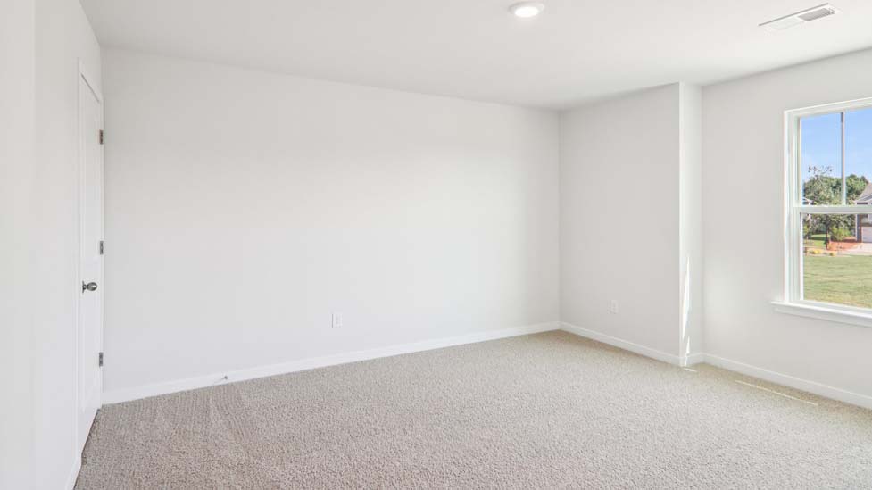 Carpeted bedroom with large window