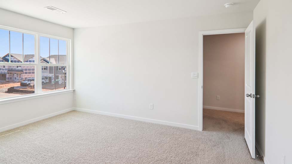 Carpeted bedroom with large window