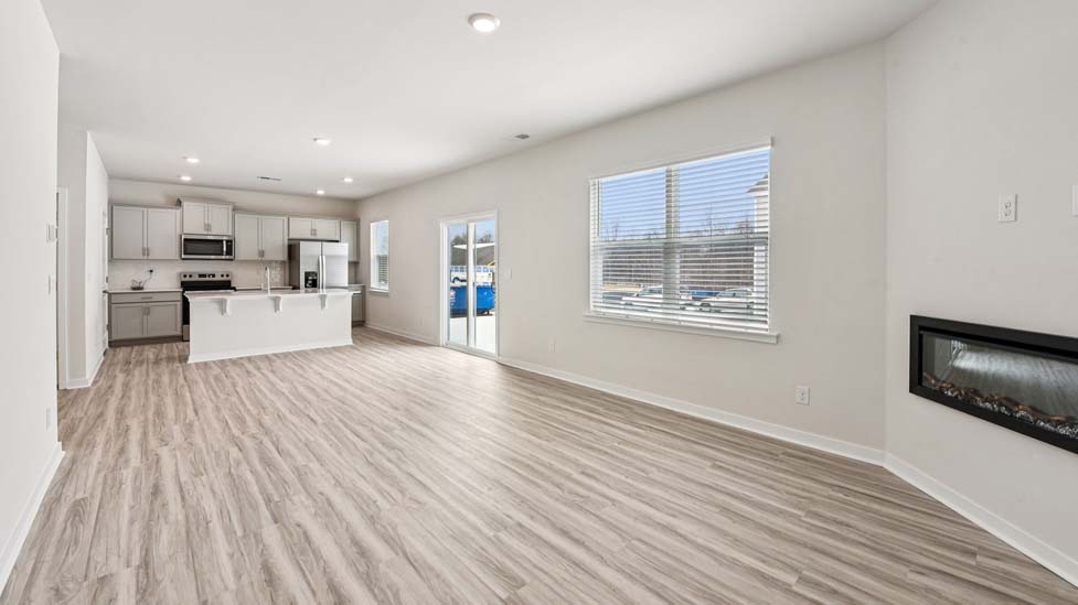 Living room beside kitchen with electric fireplace