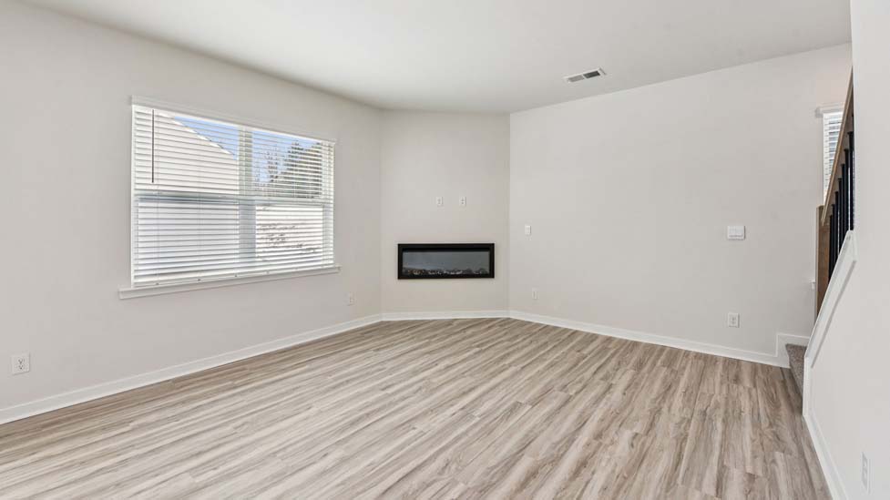 Living room beside kitchen with electric fireplace