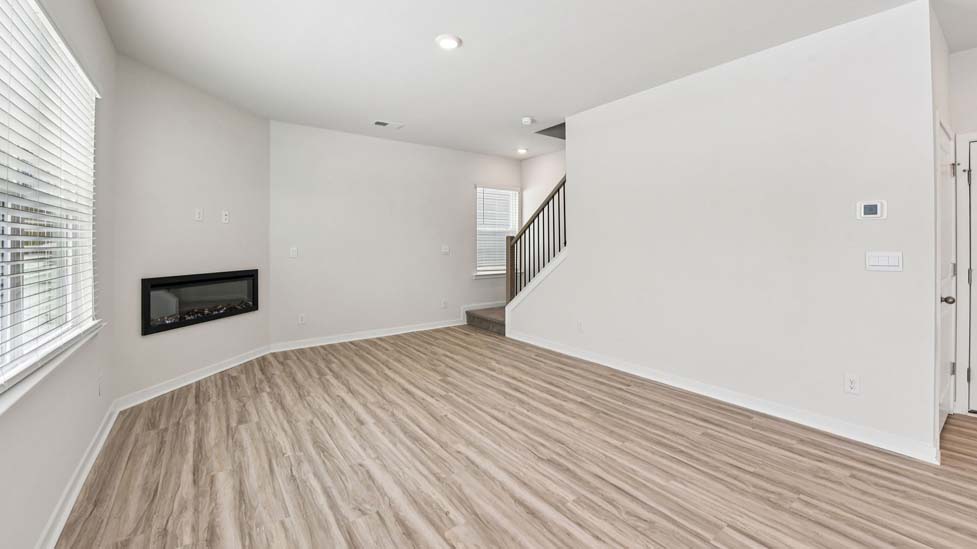 Living room beside kitchen with electric fireplace