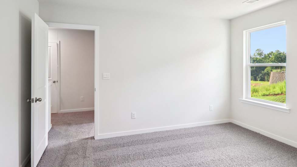 Carpeted bedroom with large window