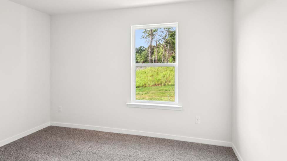 Carpeted bedroom with large window