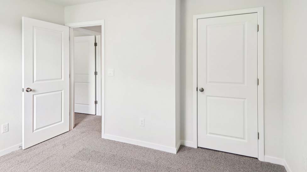 Carpeted bedroom with large window