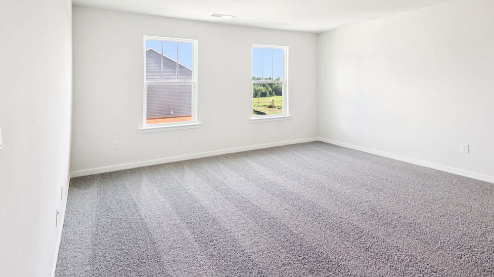 Carpeted bedroom with large window