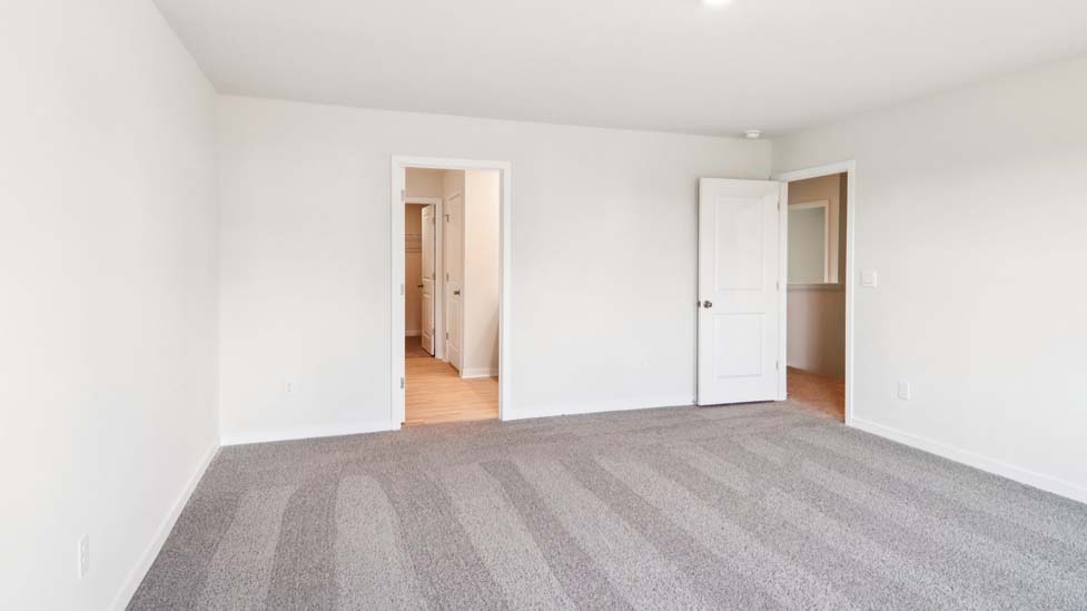 Carpeted bedroom with large window