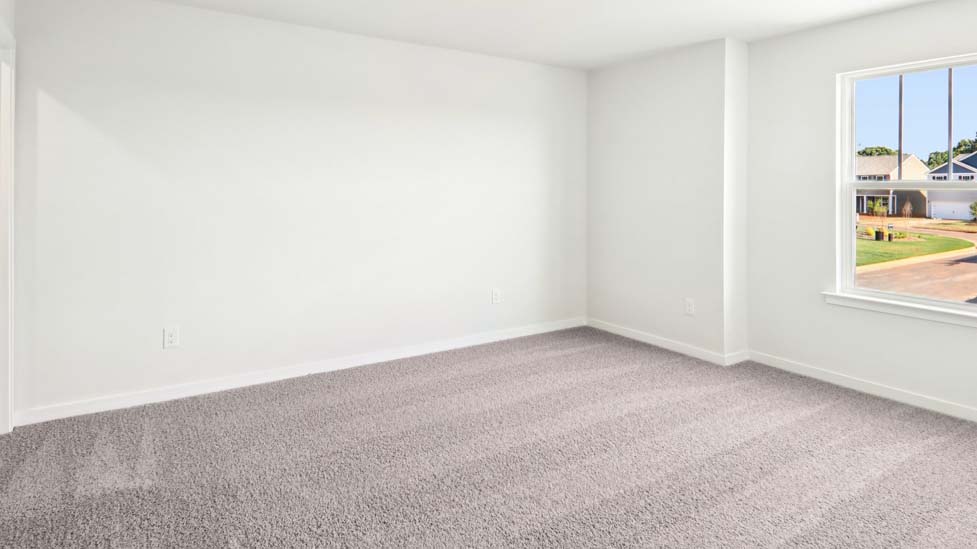 Carpeted bedroom with large window