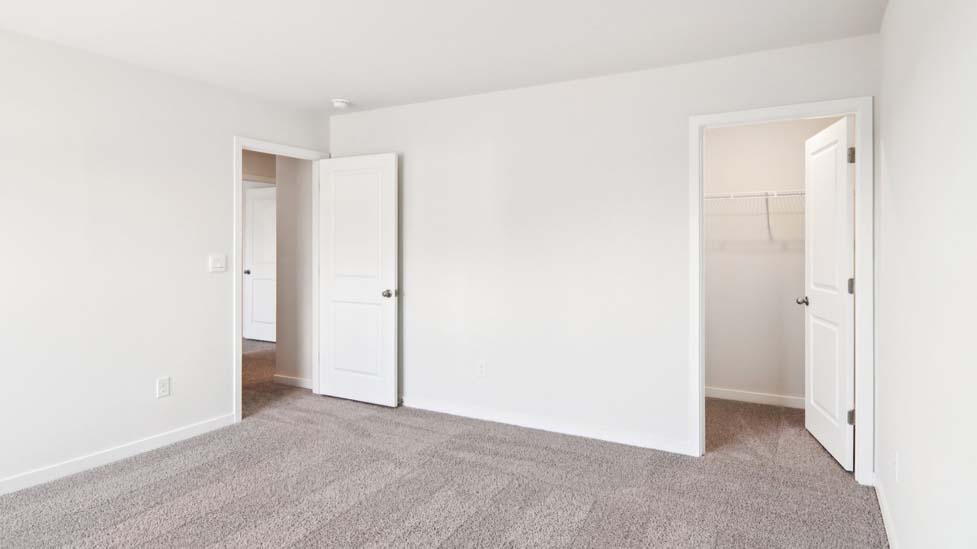 Carpeted bedroom with large window