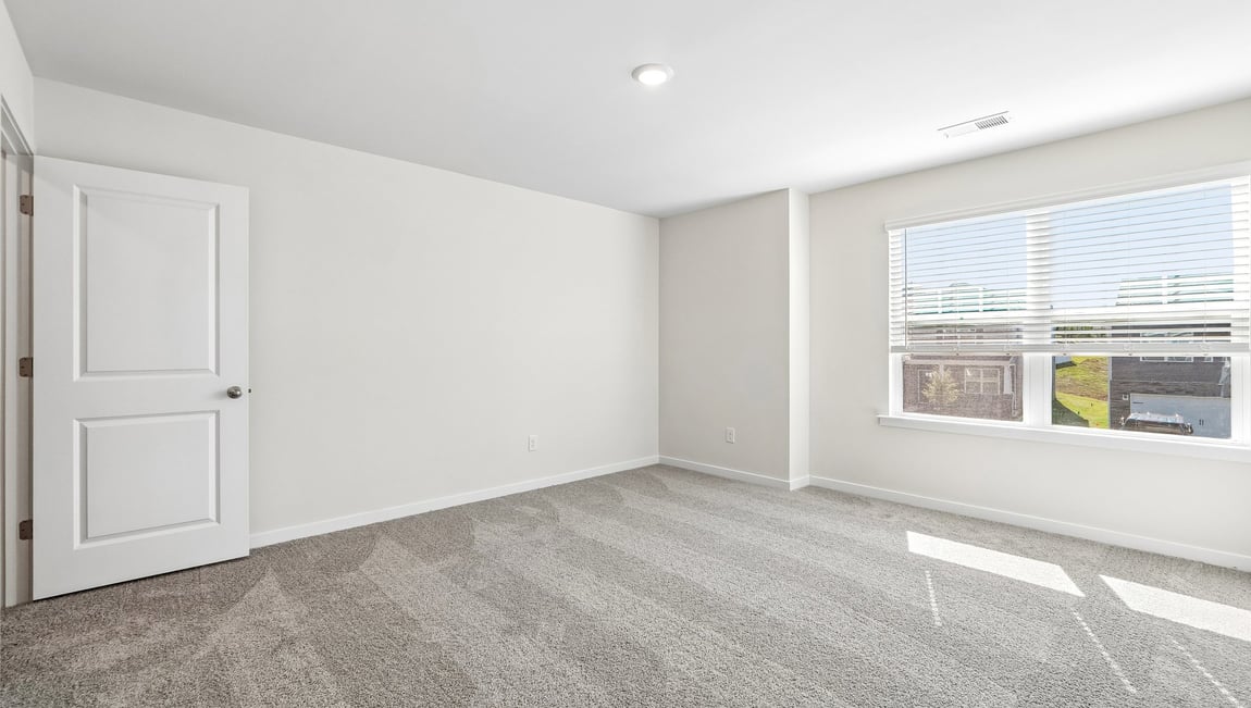 carpeted bedroom with windows
