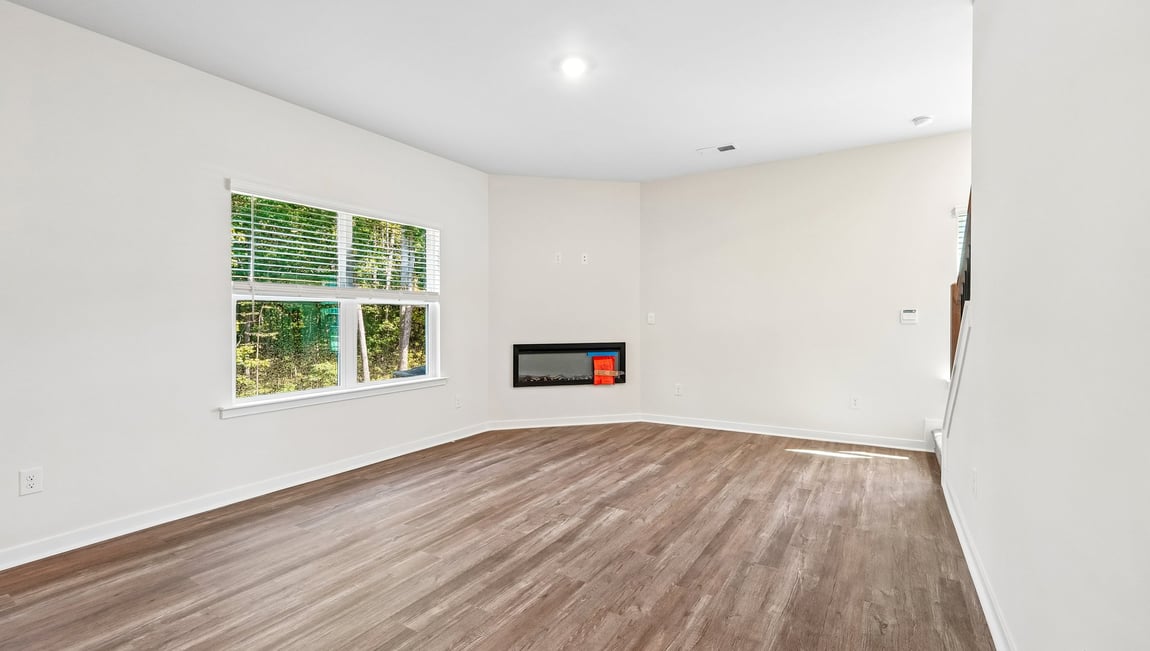 Family room with fireplace and large window