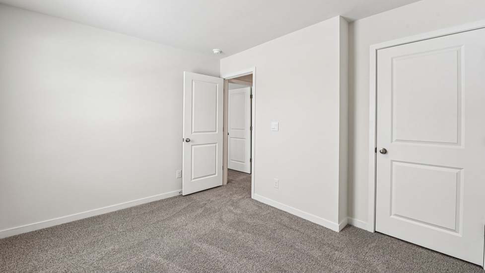 carpeted bedroom with windows