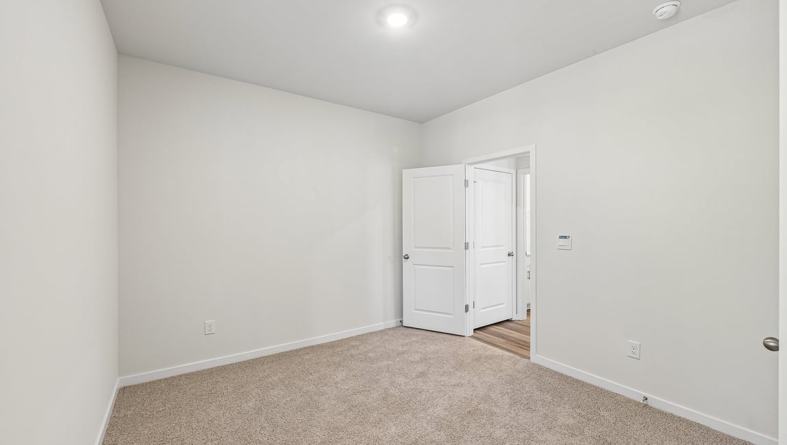 Carpeted bedroom with large window