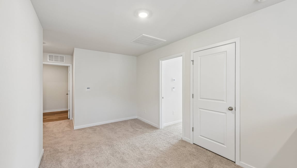 Carpeted bedroom with large window