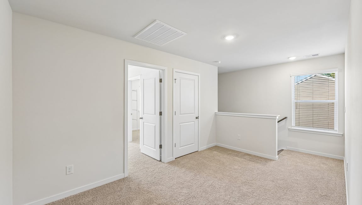 Carpeted bedroom with large window