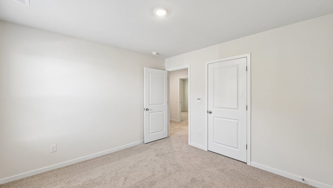 Carpeted bedroom with large window