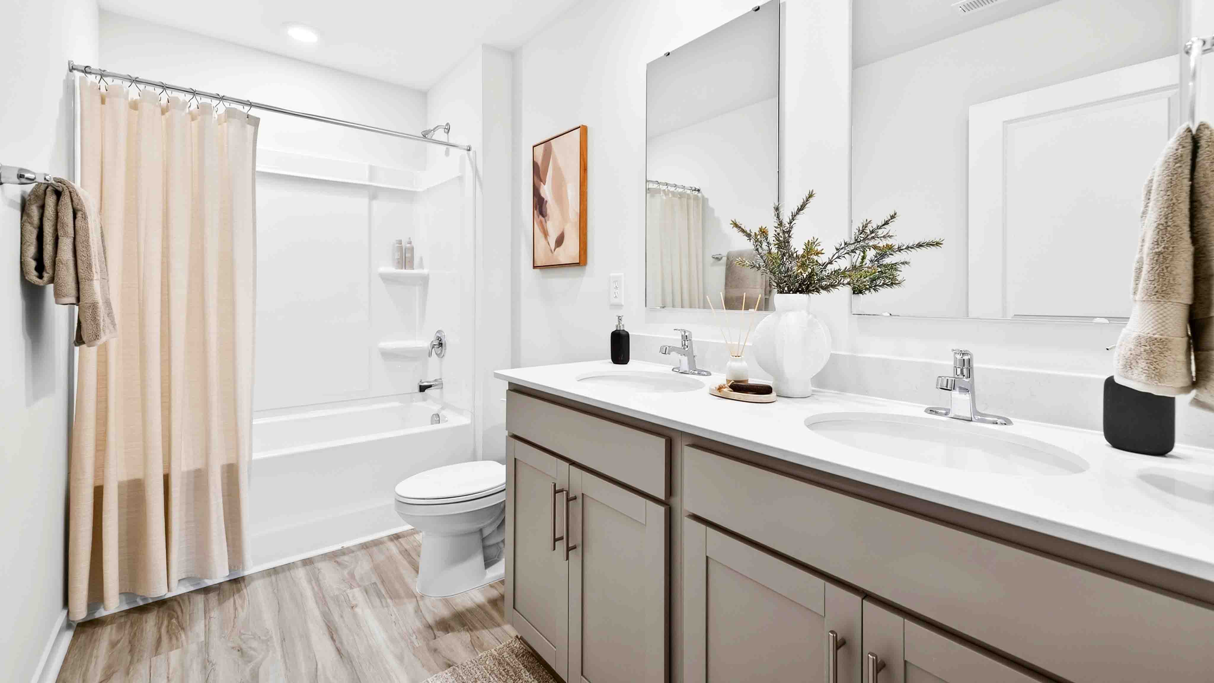 Bathroom with standing shower, white counter and cabinets