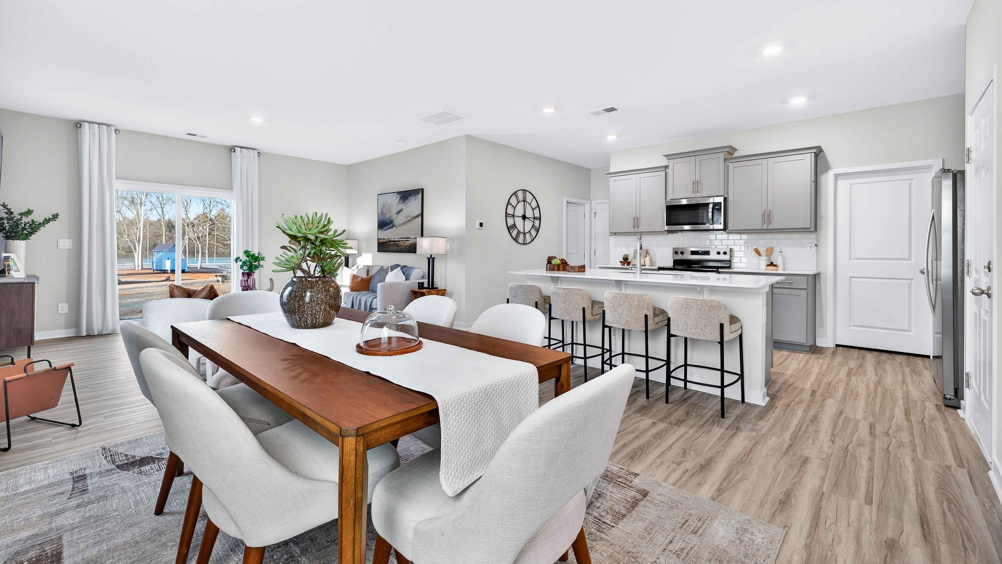 Dining Room in view of family room, wood floors, two windows alongside
