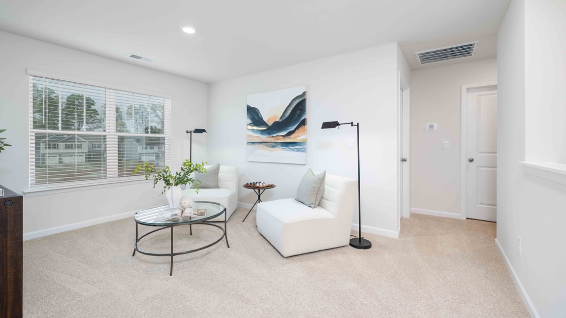 Carpeted bedroom with windows