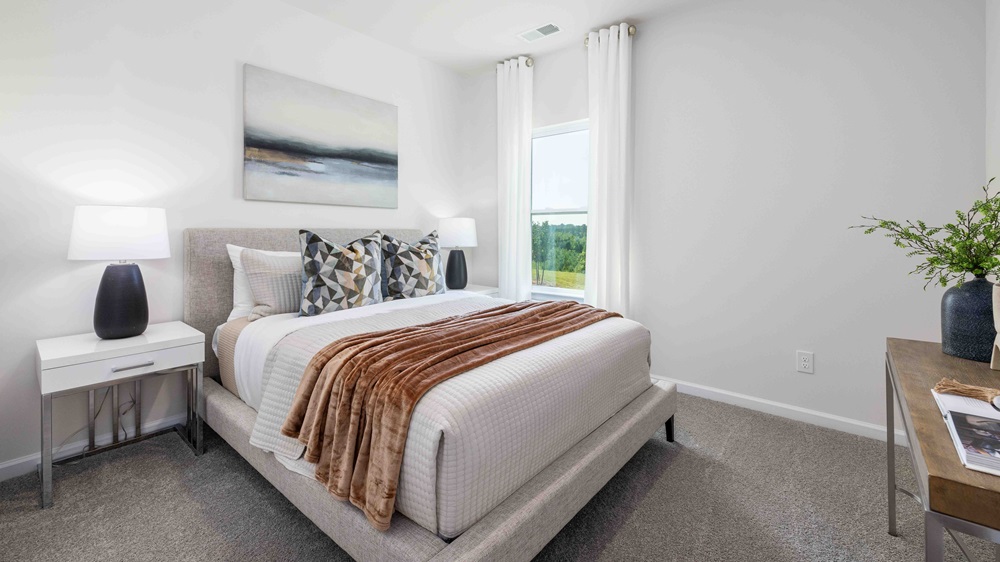 Carpeted bedroom with windows