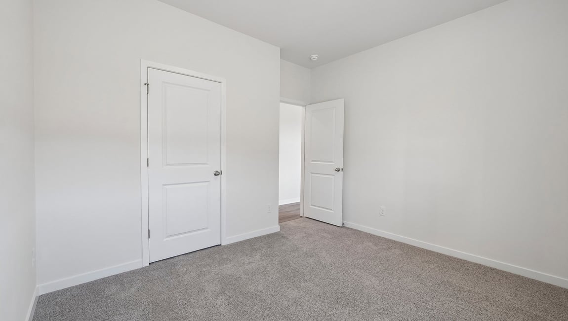 Carpeted bedroom with windows