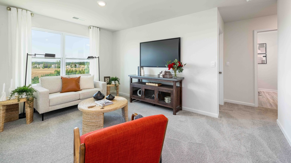 Carpeted loft with windows