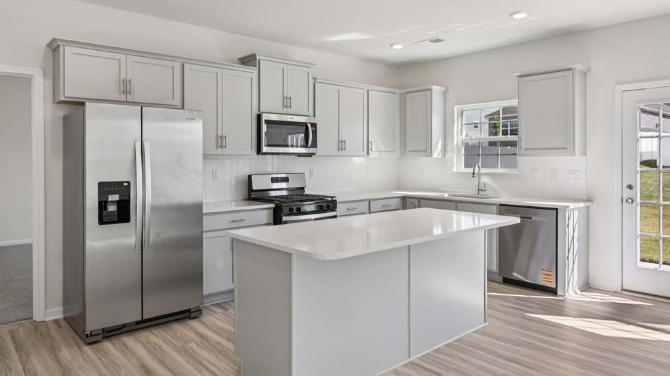 Kitchen and island with white counters and cabinets