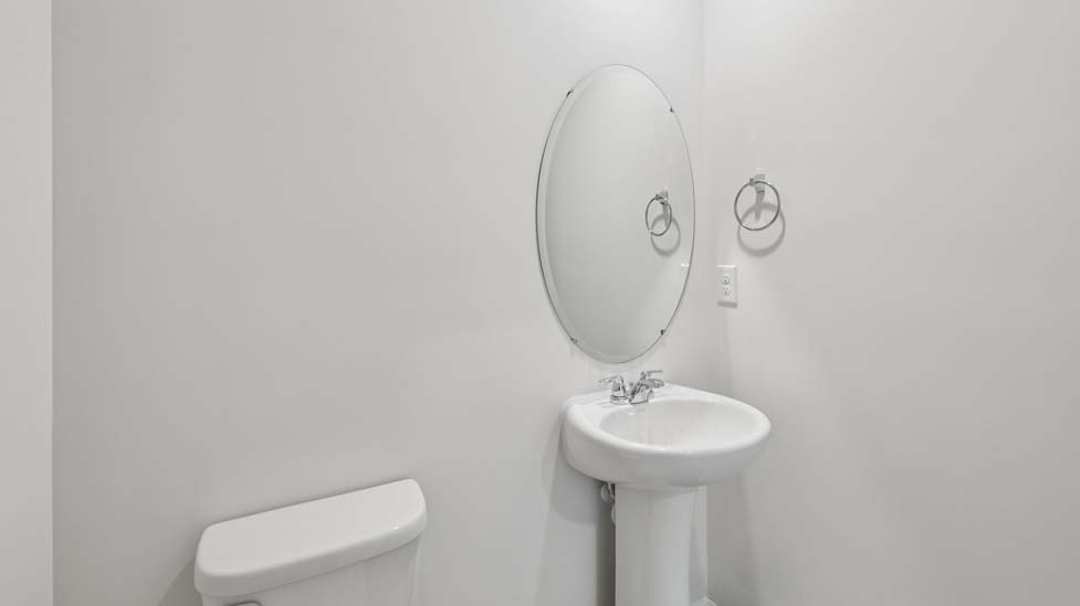 Powder bathroom with small sink and toilet