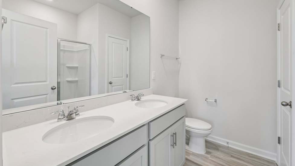 Primary bathroom with double sinks, and bathtub