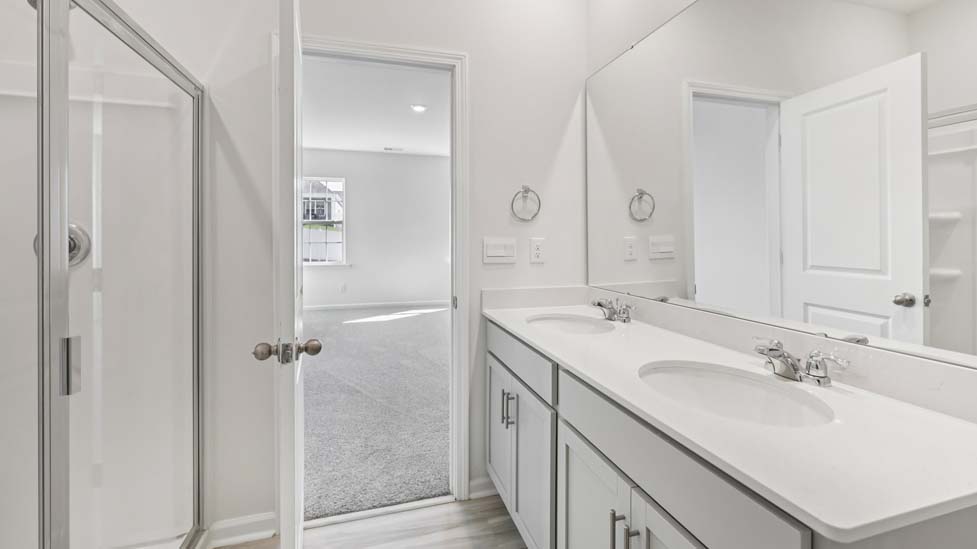 Primary bathroom with double sinks, and bathtub
