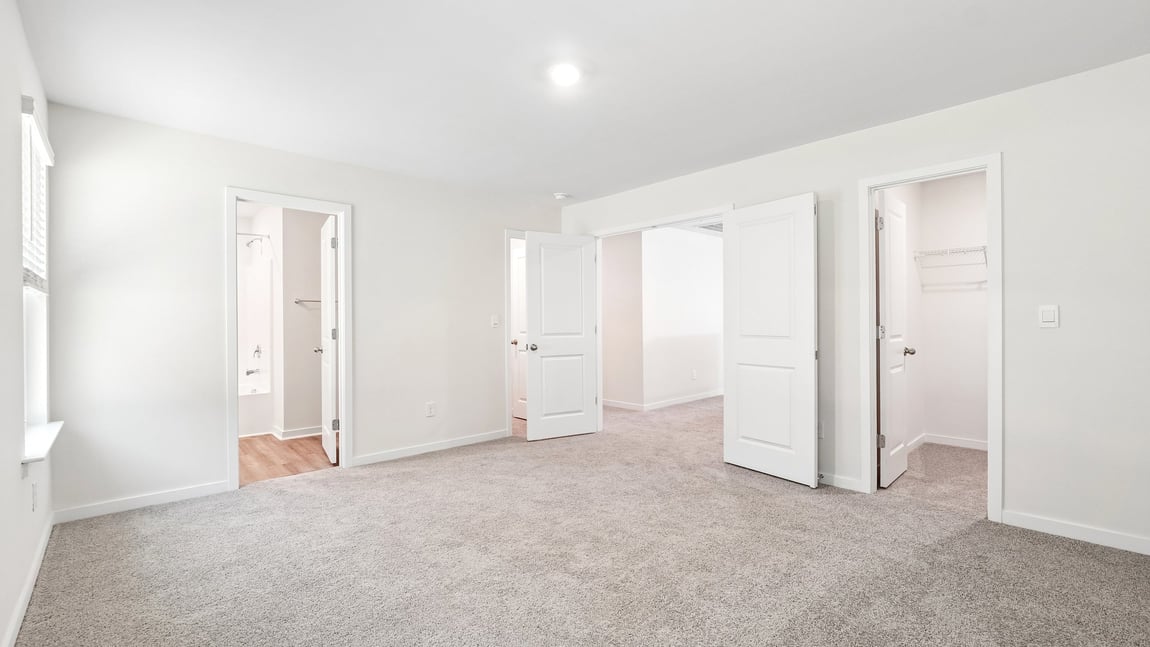 Carpeted bedroom with windows