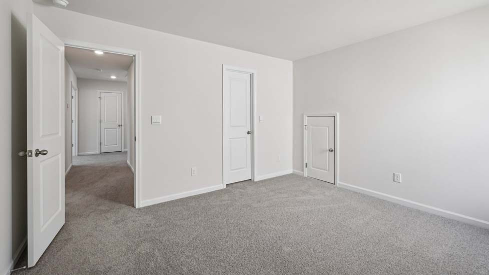 Carpeted bedroom with small window