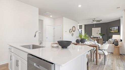 kitchen and island with white cabinets and stainless steel appliances. new home in Charlotte, NC