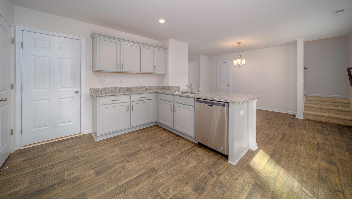 Kitchen with vinyl floors, granite counters, grey cabinets and stainless steel appliances
