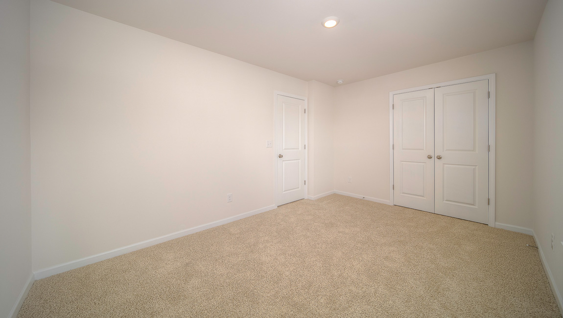 Carpeted bedroom with small window