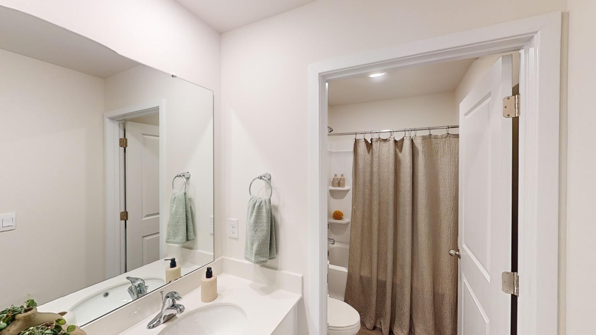 Bathroom with bathtub and double sinks