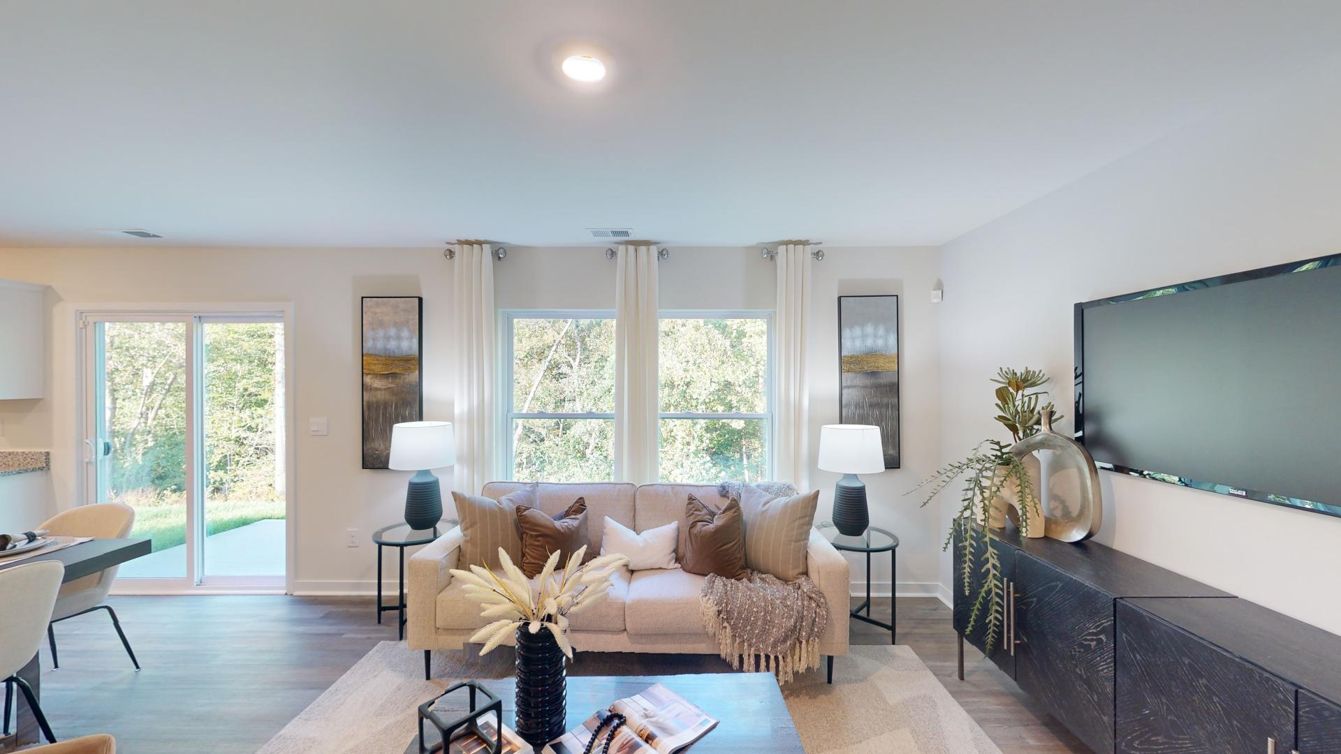 Open living room by kitchen and stairs