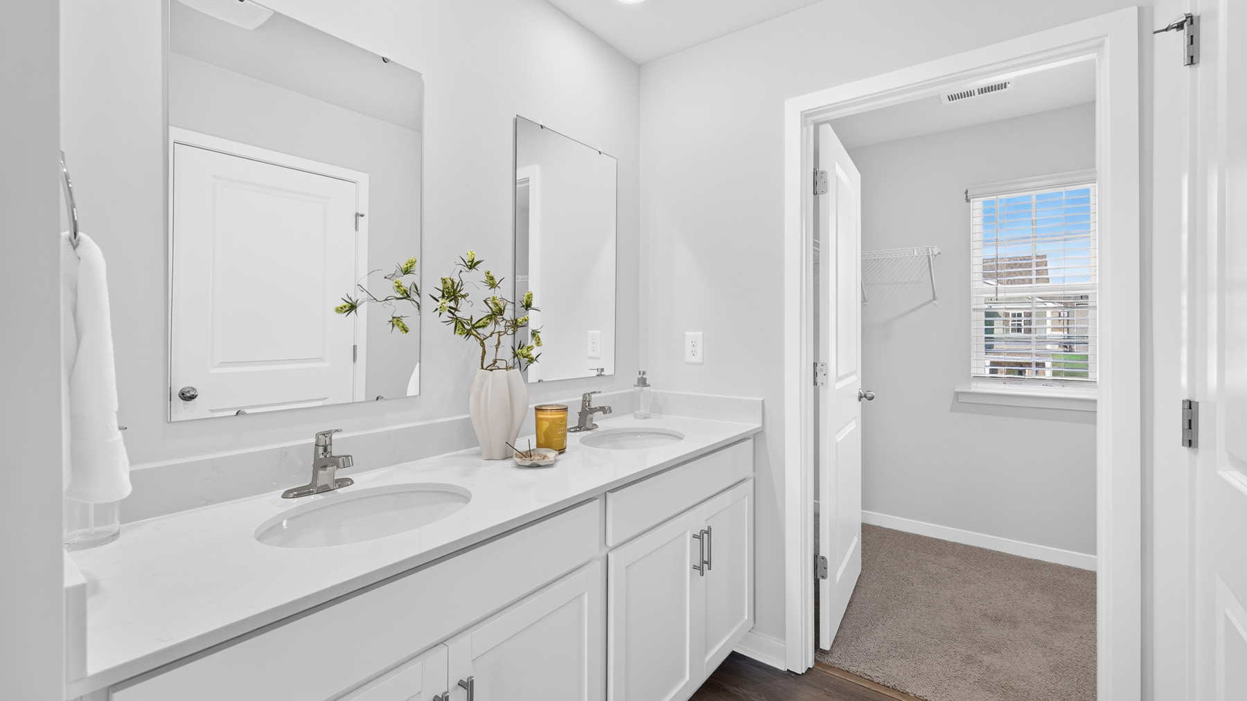 Primary bathroom with standing glass shower and double sinks